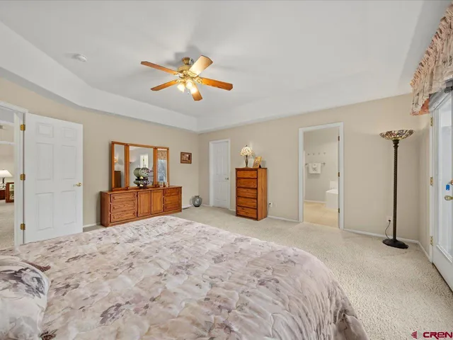 a large bedroom with a bed and a chandelier
