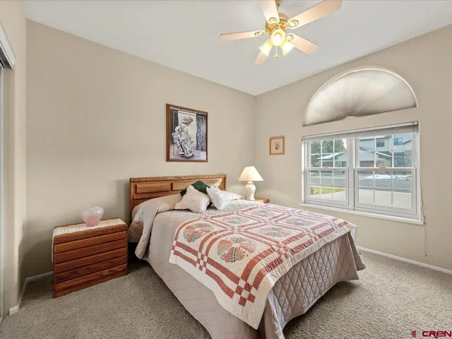 a bedroom with bed and a window