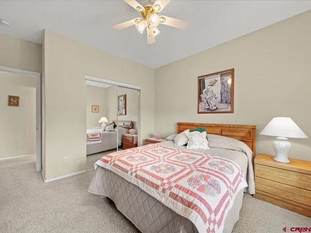 a spacious bedroom with a bed and a chandelier