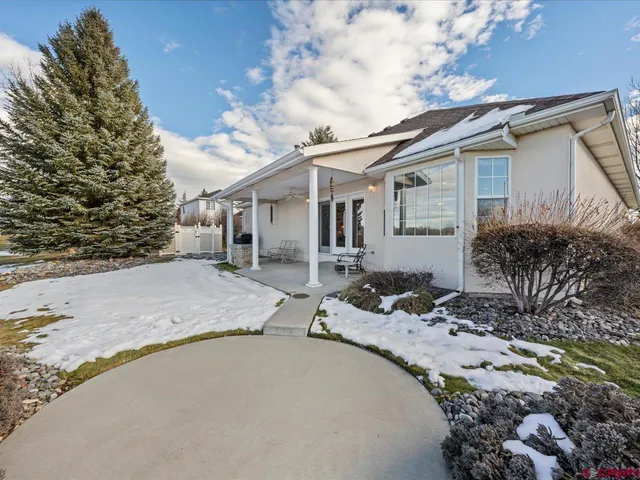 a view of a house with a snow on the road