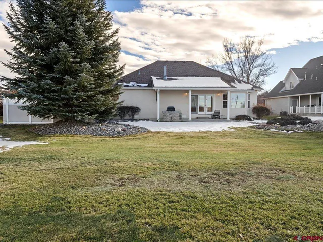 a swimming pool is sitting in front of a house