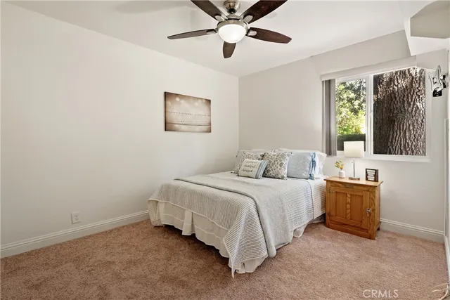 a spacious bedroom with a bed and a chandelier