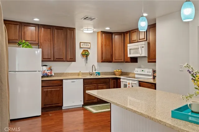 a kitchen with a sink a stove a refrigerator and a oven