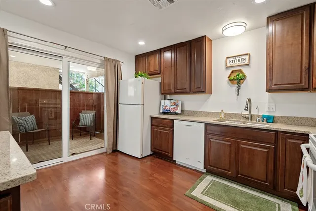 a kitchen with a refrigerator and a sink