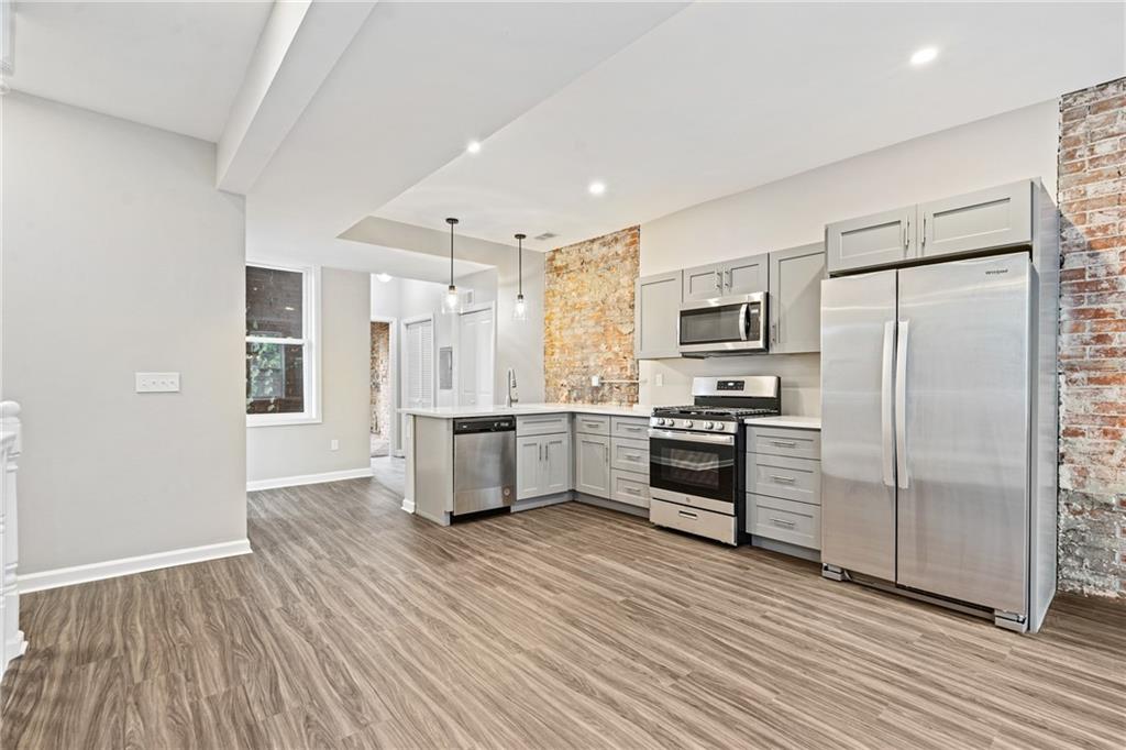 1127 Troy Hill Road Pittsburgh, PA 15212 - Photo 12 of 25 a kitchen with stainless steel appliances a refrigerator and a stove top oven