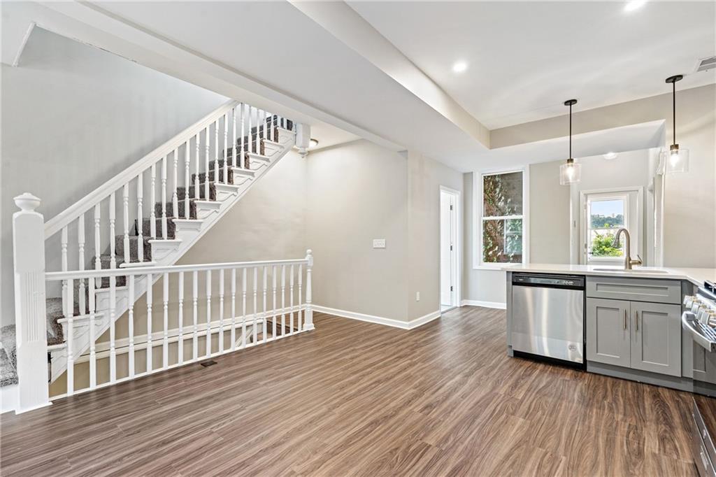 1127 Troy Hill Road Pittsburgh, PA 15212 - Photo 16 of 25 a view of a kitchen with wooden floor and stainless steel appliances