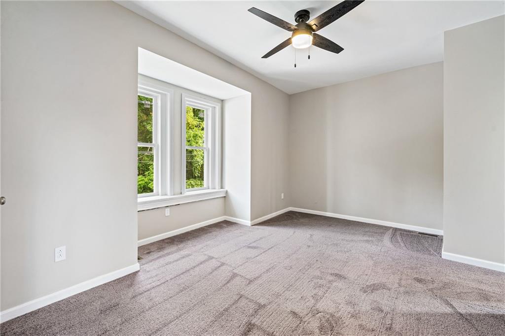 1127 Troy Hill Road Pittsburgh, PA 15212 - Photo 21 of 25 an empty room with windows and fan