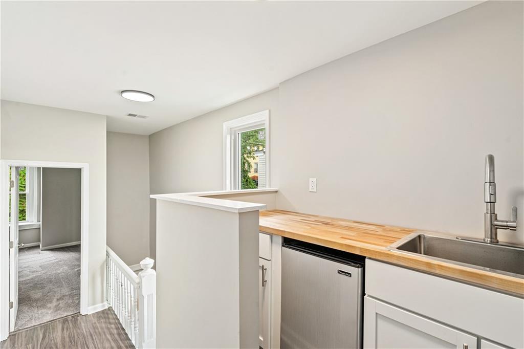 1127 Troy Hill Road Pittsburgh, PA 15212 - Photo 24 of 25 a view of a hallway with washer and dryer