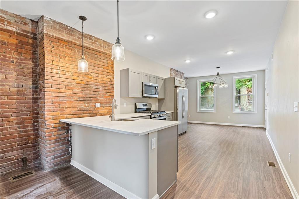 1127 Troy Hill Road Pittsburgh, PA 15212 - Photo 5 of 25 a kitchen with wooden cabinets and sink