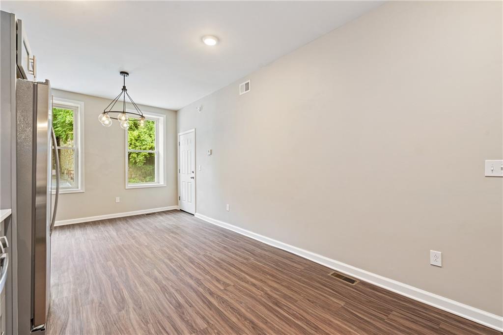 1127 Troy Hill Road Pittsburgh, PA 15212 - Photo 7 of 25 wooden floor in an empty room with a window