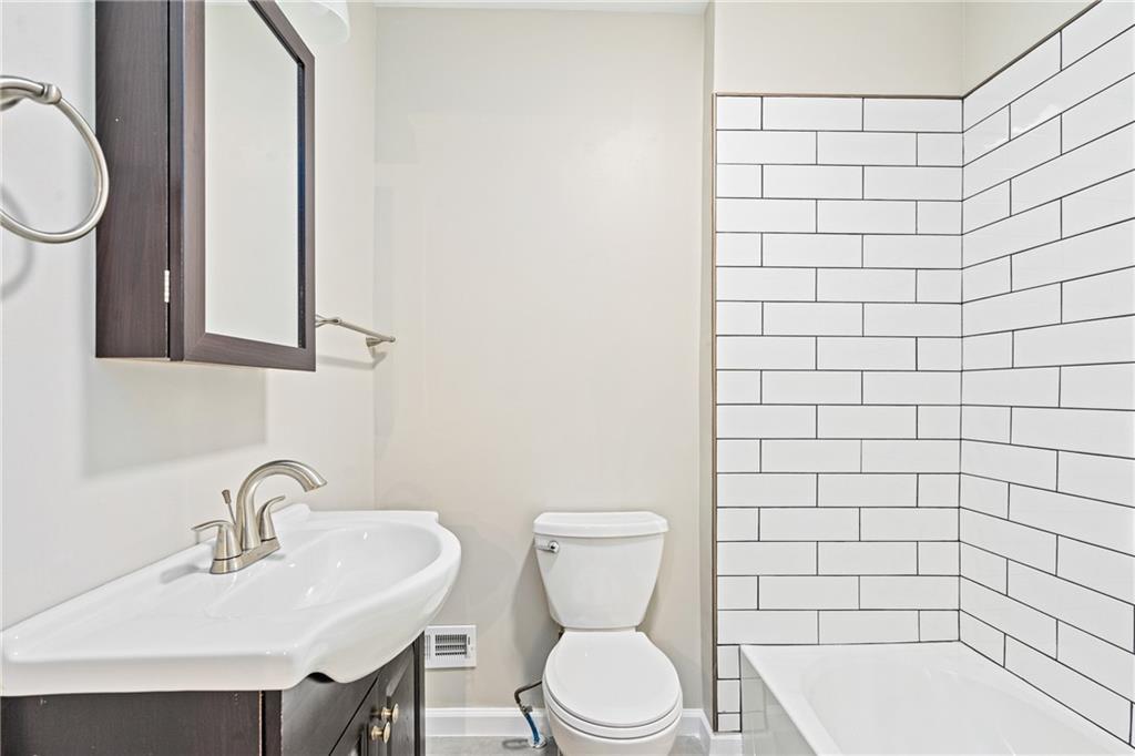 1127 Troy Hill Road Pittsburgh, PA 15212 - Photo 8 of 25 a bathroom with a sink a toilet and mirror