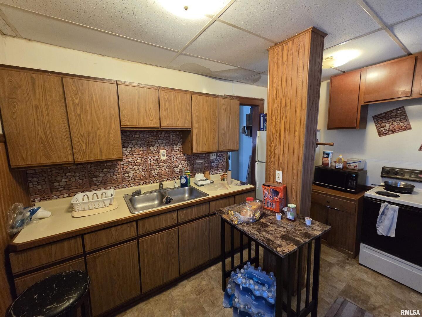 800 6th Avenue South Clinton, IA 52732 - Photo 12 of 12 a kitchen with a sink stove and cabinets