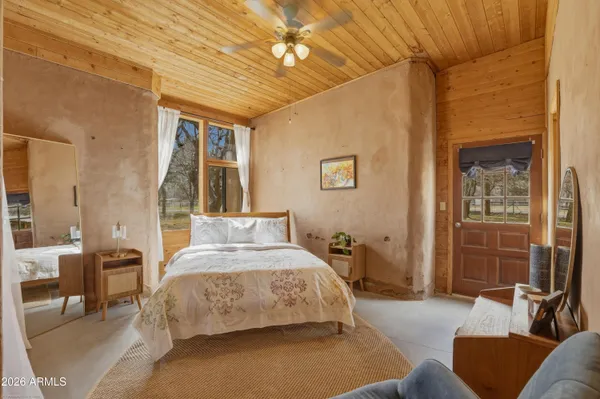 a bedroom with a bed a couch and dresser