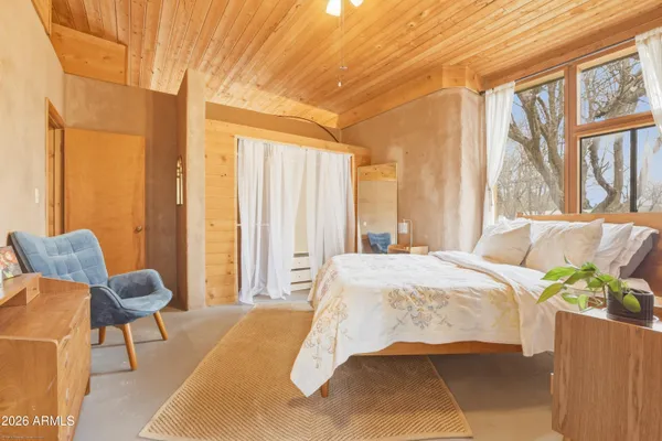 a bedroom with a bed and a window