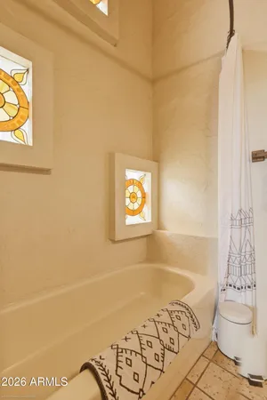 a bathroom with a bathtub and shower
