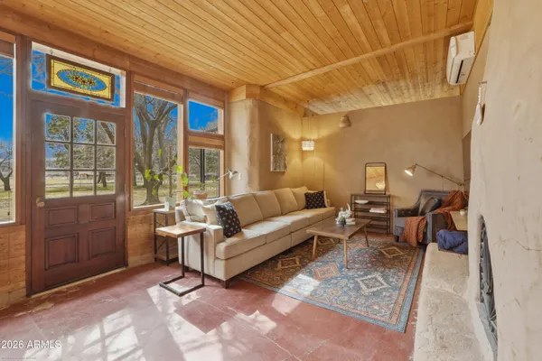 a living room with furniture a lamp and a window