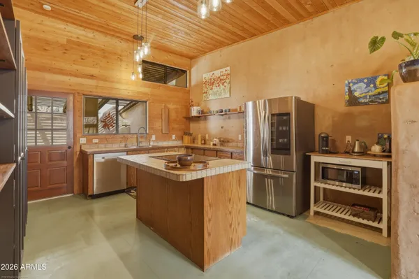 a kitchen with a stove a refrigerator and a sink