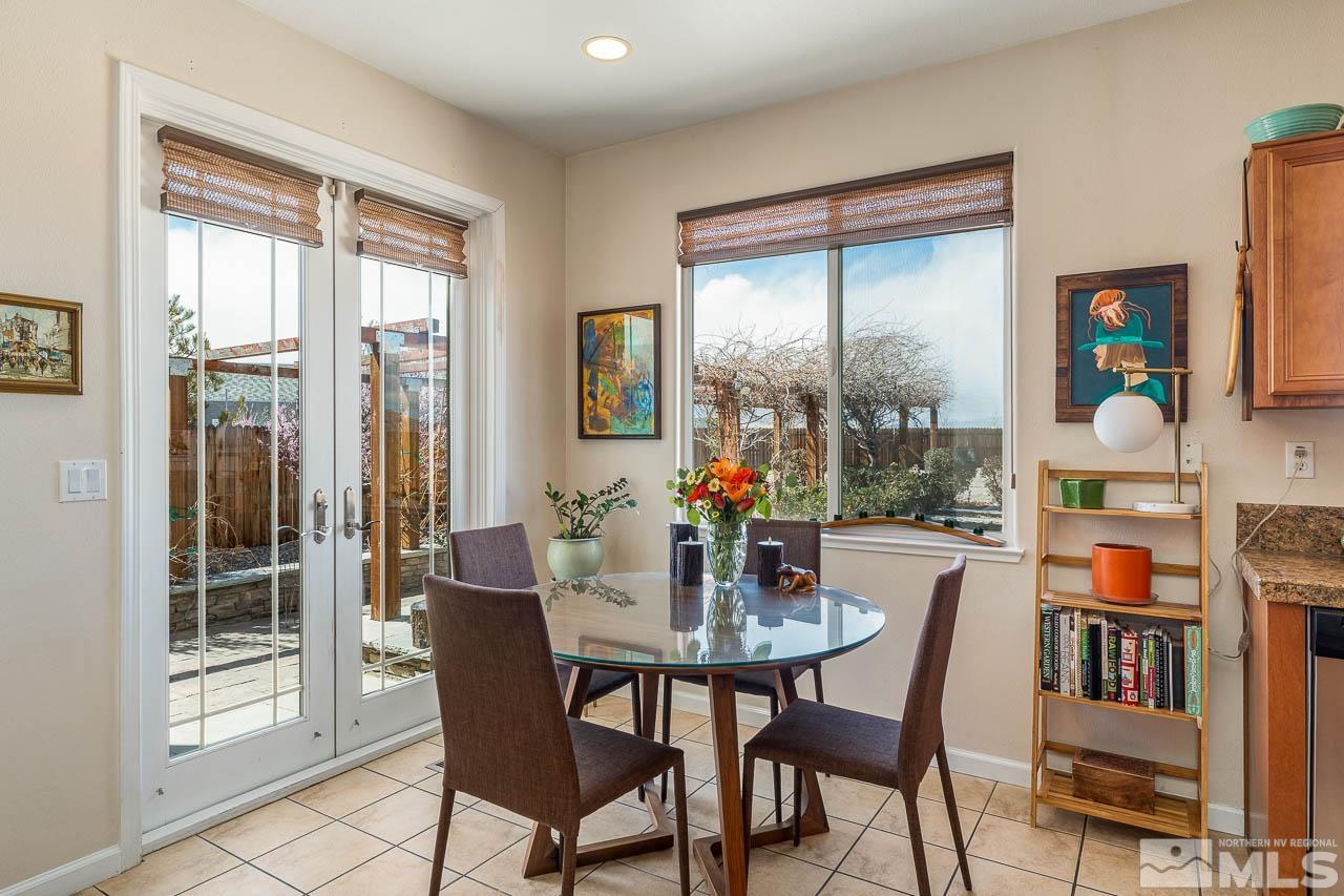 2241 Big Trail Circle Reno, NV 89521 - Photo 18 of 40 a dining room with furniture a rug and a floor to ceiling window