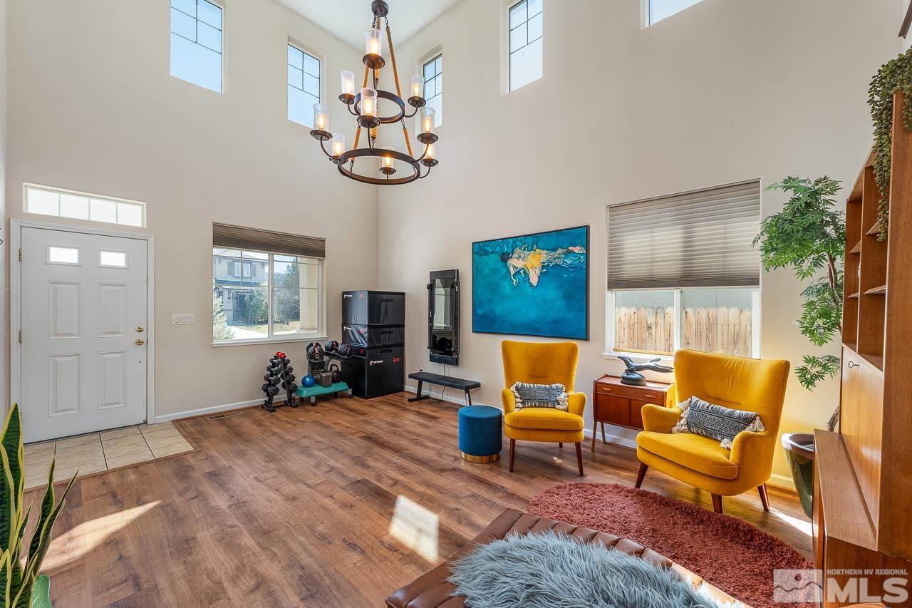 2241 Big Trail Circle Reno, NV 89521 - Photo 2 of 40 a living room with furniture a fireplace and a chandelier