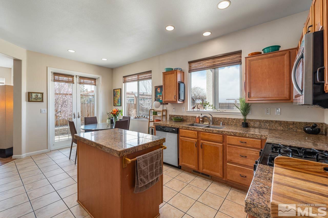 2241 Big Trail Circle Reno, NV 89521 - Photo 21 of 40 a kitchen with kitchen island granite countertop a sink and a stove top oven