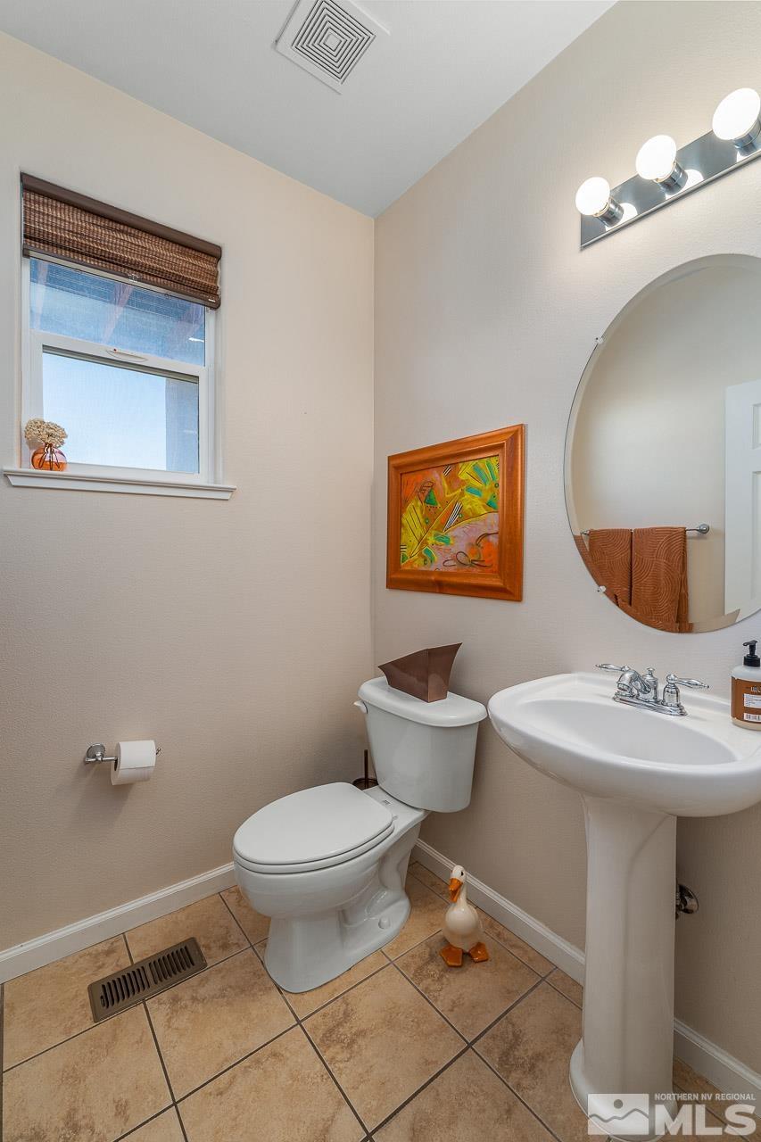 2241 Big Trail Circle Reno, NV 89521 - Photo 23 of 40 a bathroom with a toilet a sink and mirror