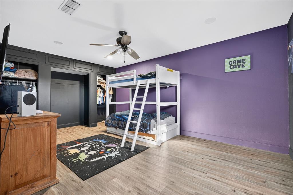 605 Highway 36 Comanche, TX 76442 - Photo 15 of 36 a bedroom with a bed and a wooden floor