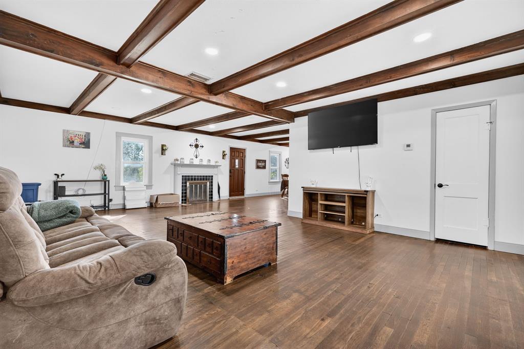 605 Highway 36 Comanche, TX 76442 - Photo 9 of 36 a living room with furniture a fireplace and a flat screen tv