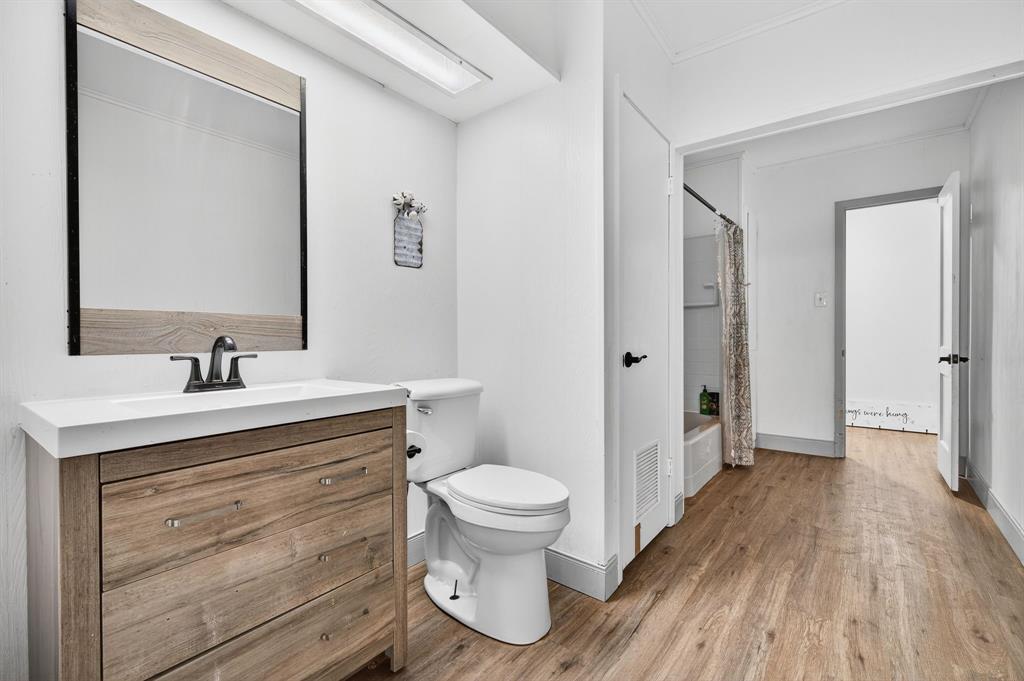 605 Highway 36 Comanche, TX 76442 - Photo 10 of 36 a bathroom with a sink a toilet a large mirror and shower