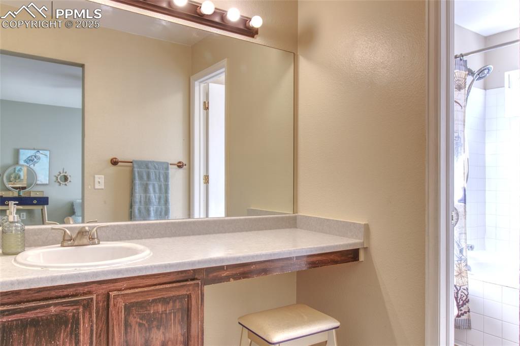 7215 Canal Point Colorado Springs, CO 80922 - Photo 15 of 24 a bathroom with a sink and a mirror