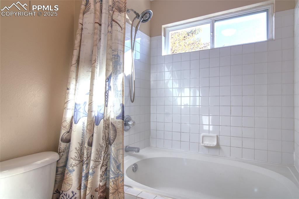 7215 Canal Point Colorado Springs, CO 80922 - Photo 16 of 24 a bathroom with a bathtub and shower