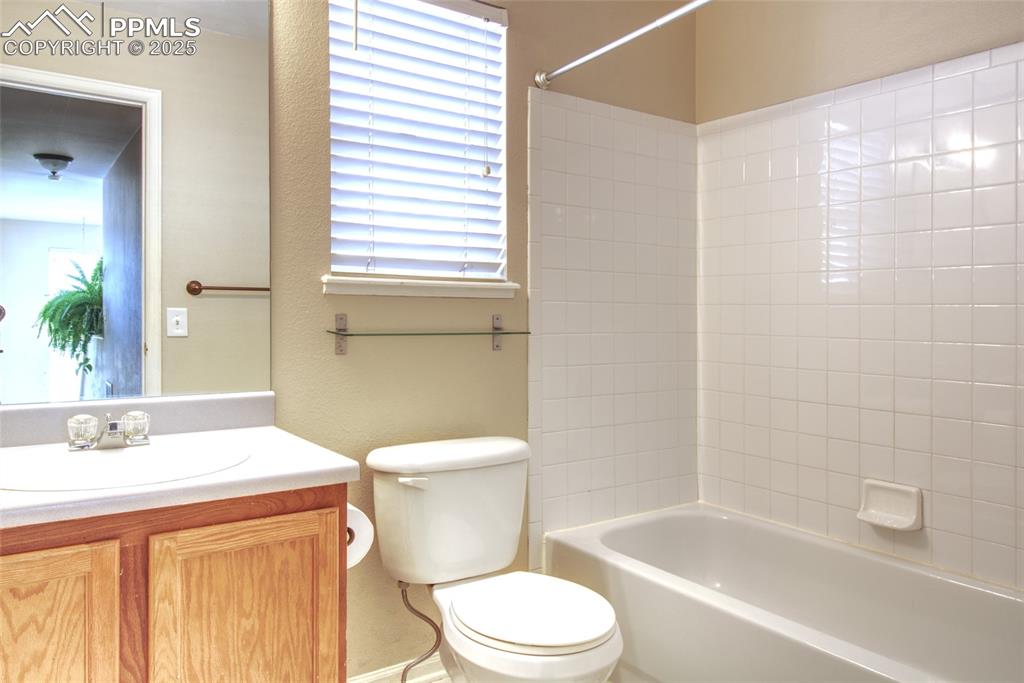 7215 Canal Point Colorado Springs, CO 80922 - Photo 18 of 24 a bathroom with a sink a toilet and shower