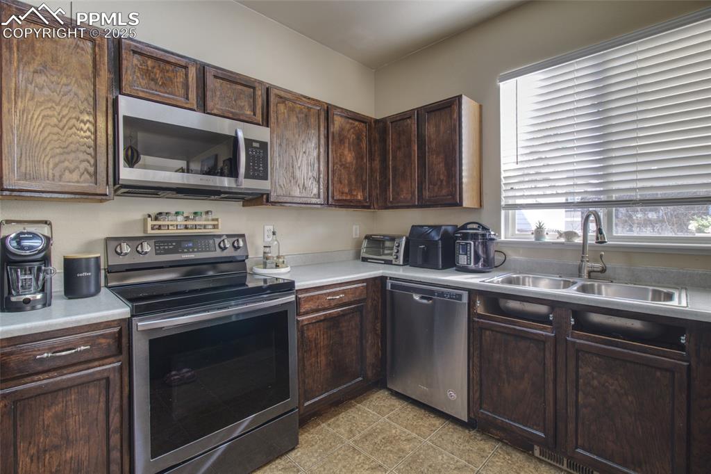 7215 Canal Point Colorado Springs, CO 80922 - Photo 8 of 24 a kitchen with a sink stove and microwave