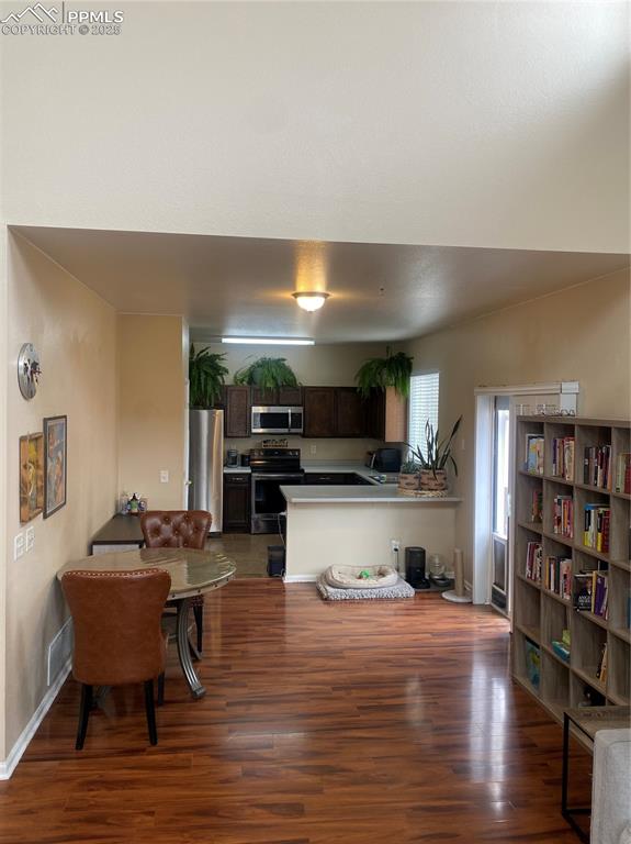 7215 Canal Point Colorado Springs, CO 80922 - Photo 9 of 24 a living room with furniture and a wooden floor