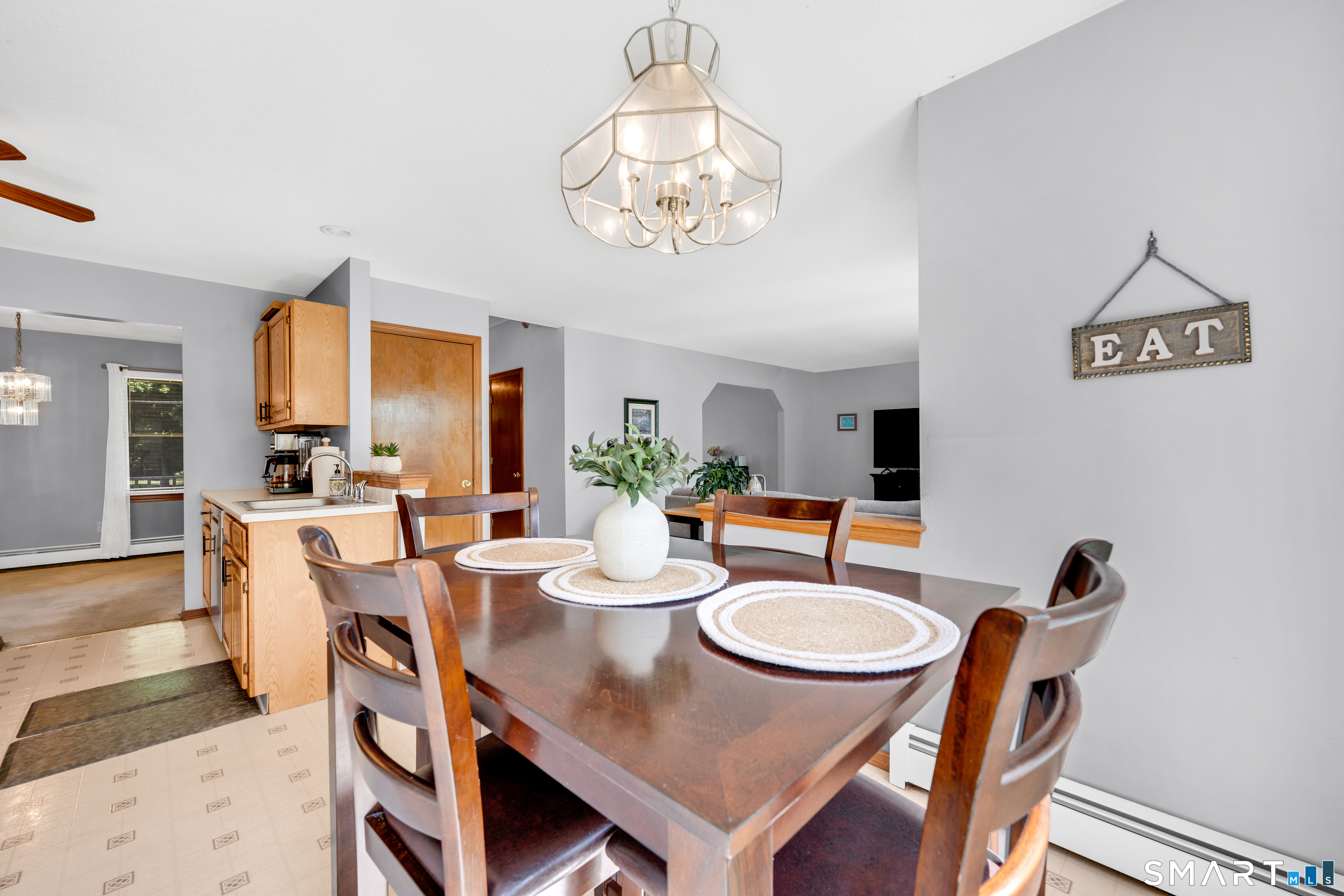 89 Windsorville Road South Windsor, CT 06074 - Photo 5 of 23 a view of a dining room with furniture a chandelier and wooden floor