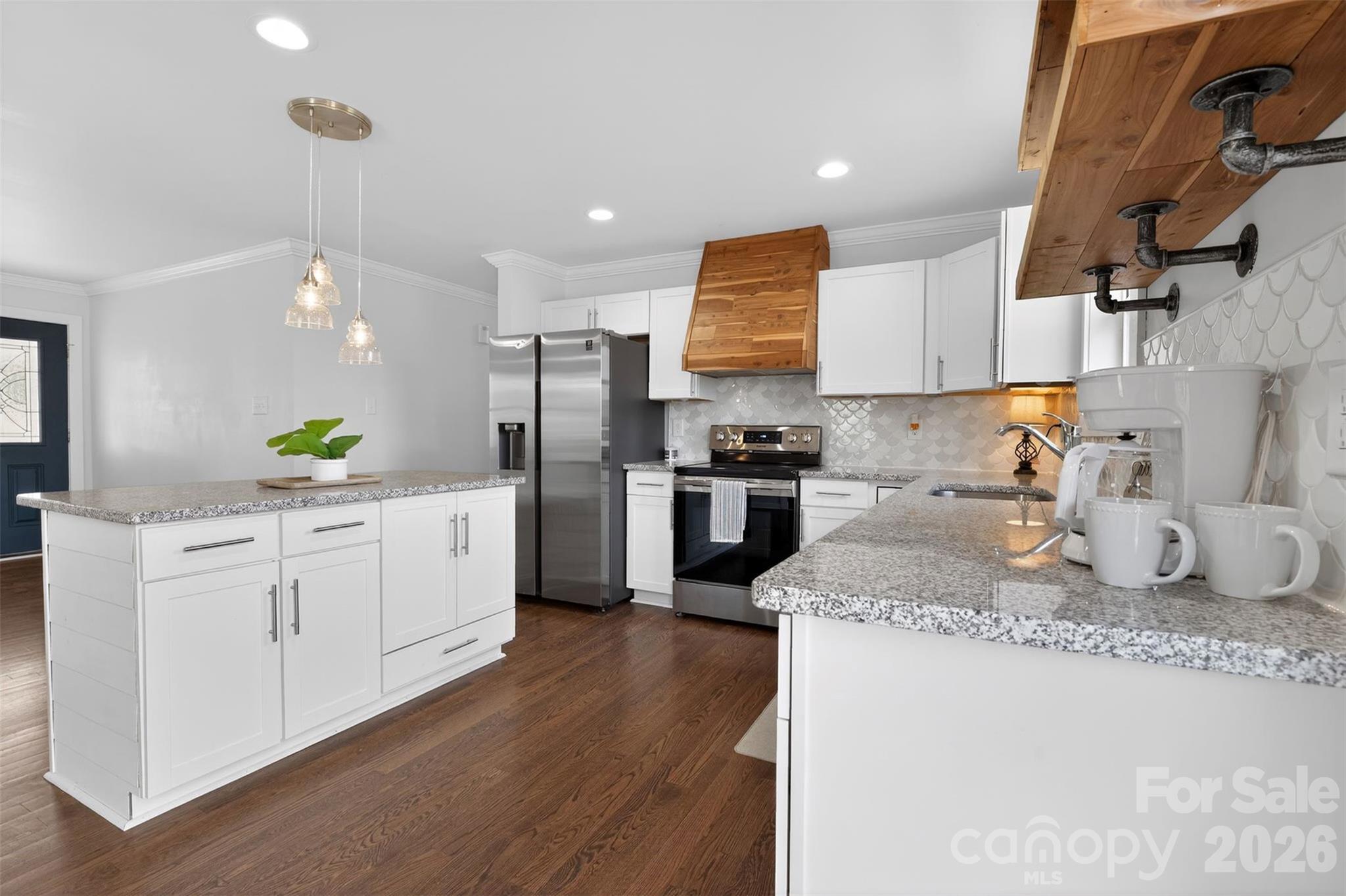 a kitchen with sink refrigerator and microwave