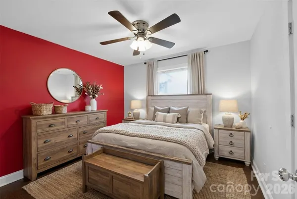 a bedroom with a large bed and a chandelier