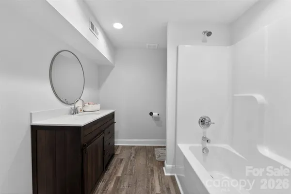 a bathroom with a sink a mirror and a bathtub
