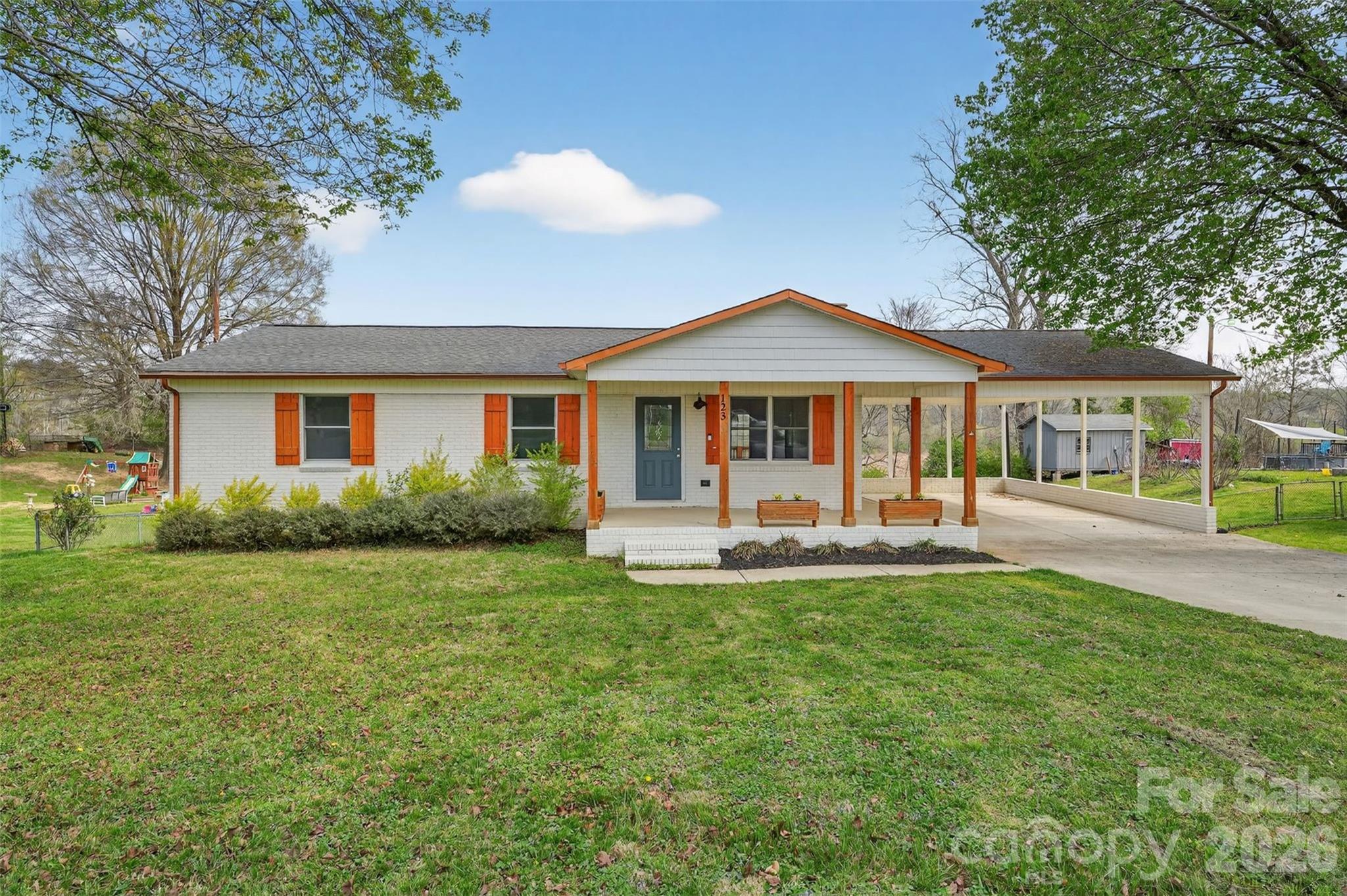 123 Rowe Street Gastonia, NC 28056 - Photo 3 of 20 a front view of a house with swimming pool having outdoor seating