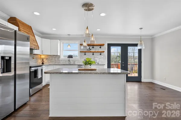 a kitchen with counter top space cabinets and stainless steel appliances