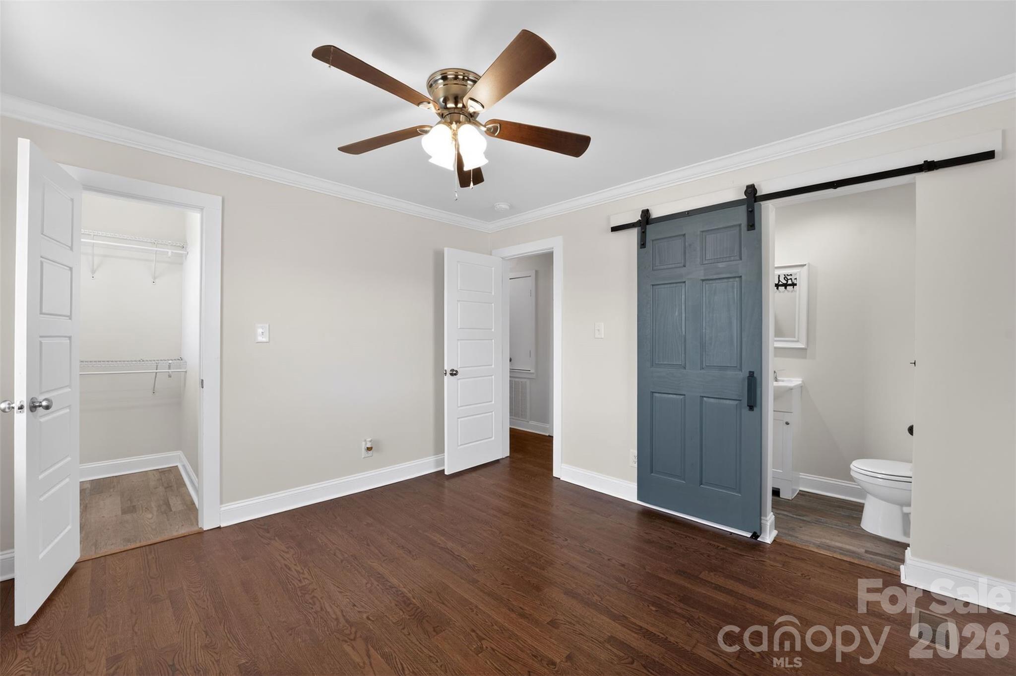 123 Rowe Street Gastonia, NC 28056 - Photo 8 of 20 a view of a livingroom with a hardwood floor and a ceiling fan