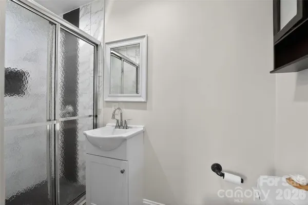 a bathroom with a sink a mirror and shower