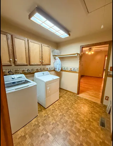 a kitchen with granite countertop a stove a sink and dishwasher wooden cabinets with granite countertops