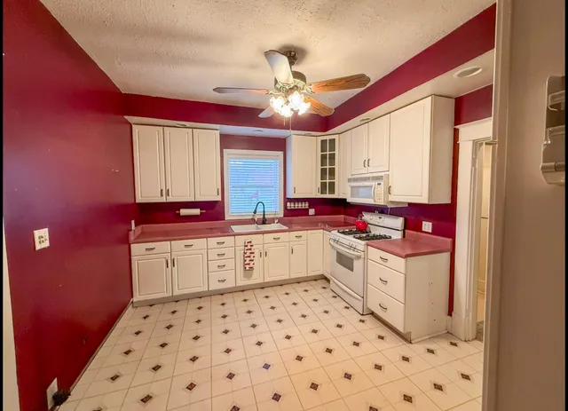 a kitchen with stainless steel appliances a sink and a refrigerator