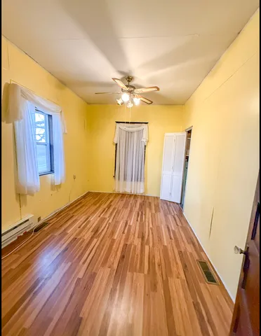 a view of a livingroom with furniture window and wooden floor