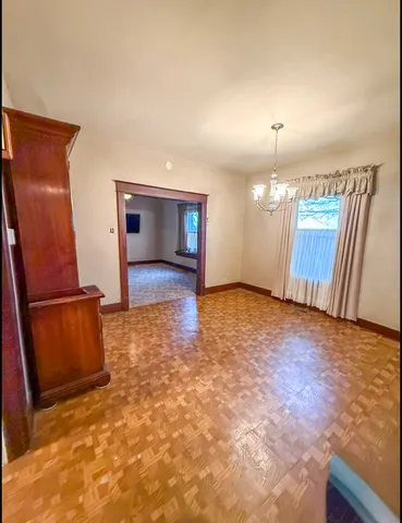 a view of an empty room with a fireplace and a window