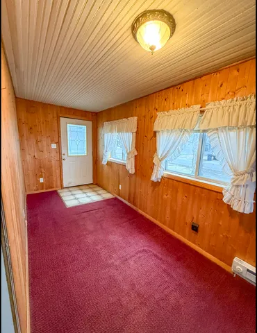 a view of an empty room and a window