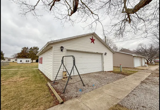 a view of a house with a yard and wooden fence