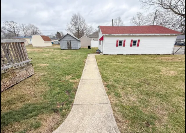 a view of residential houses with yard