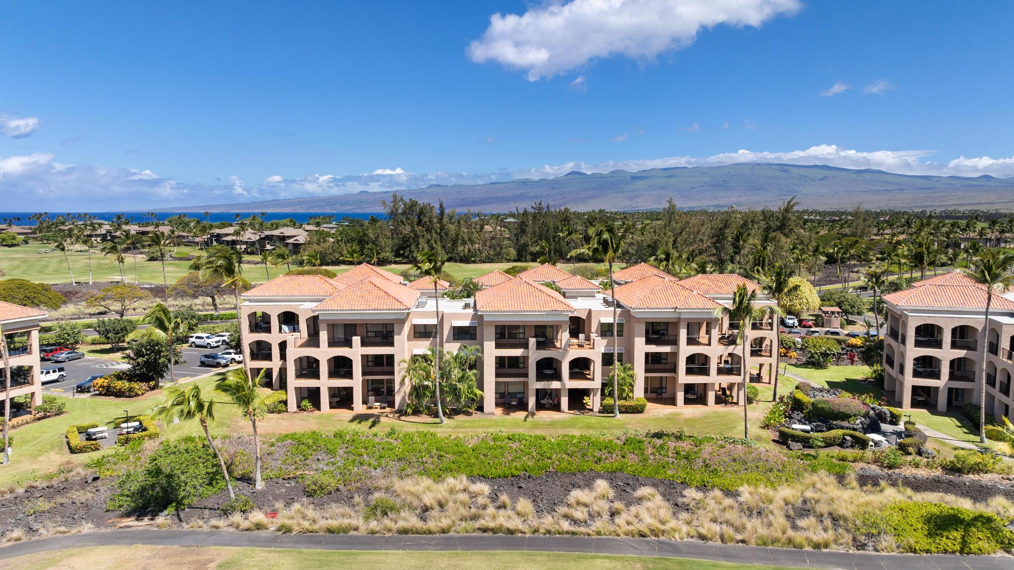 69-450 Bay Club, Unit 236 Waikoloa, HI 96738 - Photo 1 of 22 a view of a large building with a yard and front a yard