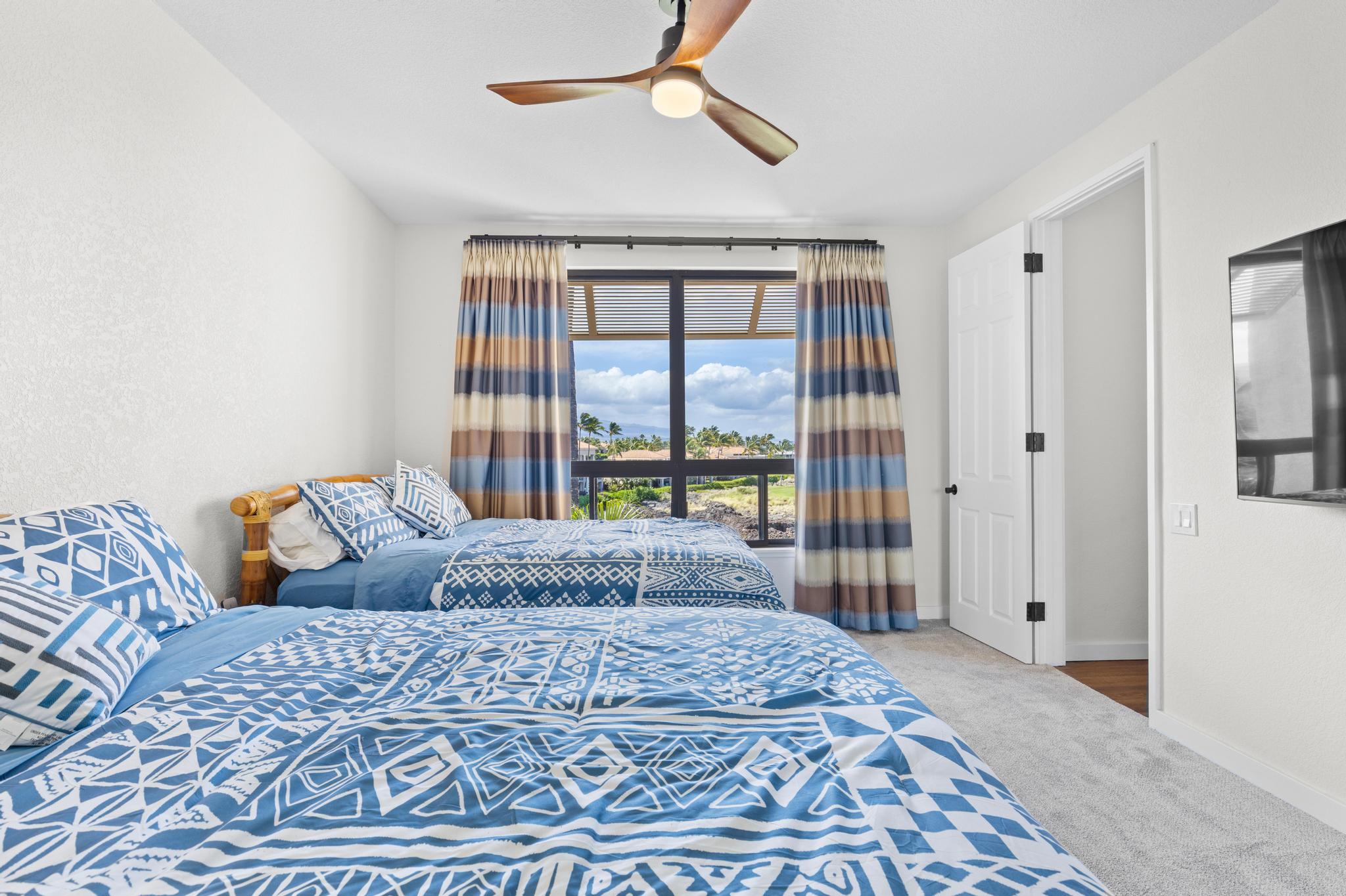 69-450 Bay Club, Unit 236 Waikoloa, HI 96738 - Photo 12 of 22 a bedroom with a large bed and a chandelier